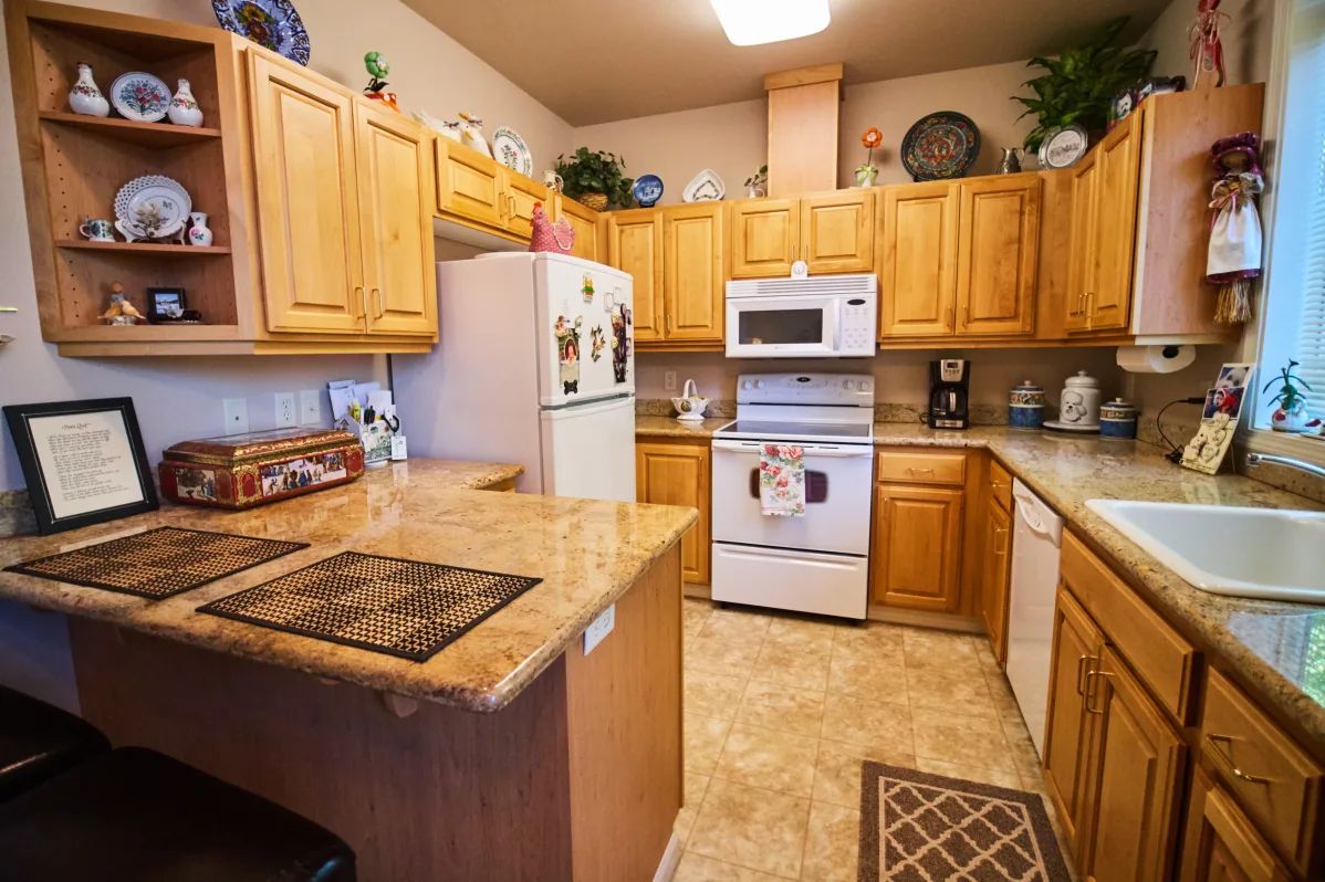 A cozy kitchen with wooden cabinets and modern appliances.