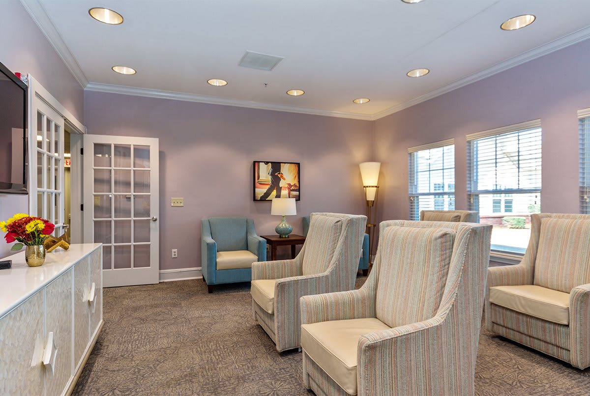 A cozy lounge area with comfortable chairs and warm lighting.