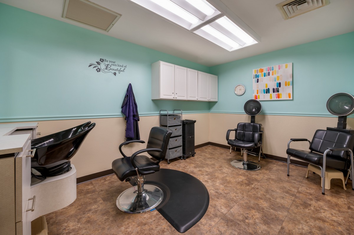 Interior view of a hair salon with styling chairs and equipment.