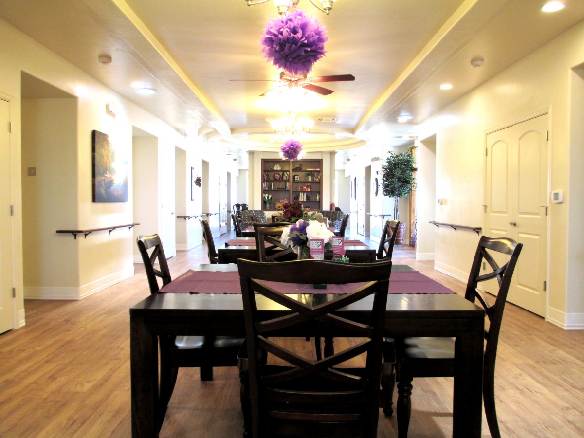 A modern dining area with elegant furniture and decorative lighting.