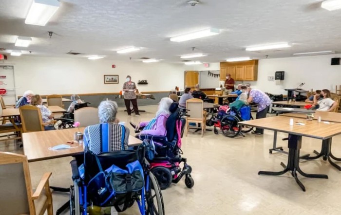 Elderly individuals in a nursing home participating in a group activity.