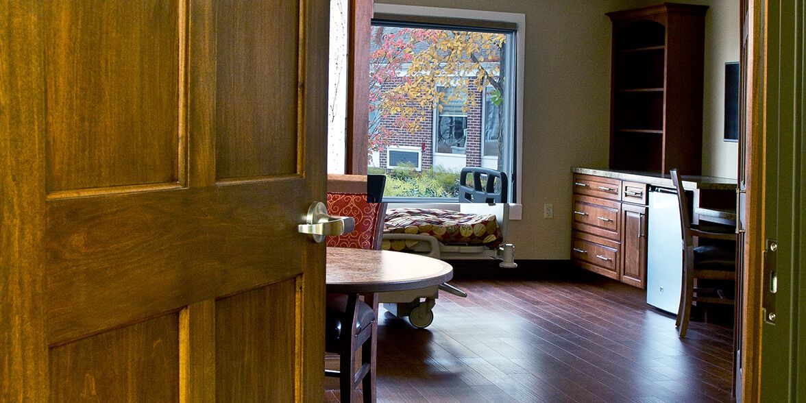 A cozy room with an open door leading to a window view.