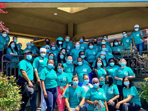 A dedicated team coming together for a community service event, showcasing unity and safety.