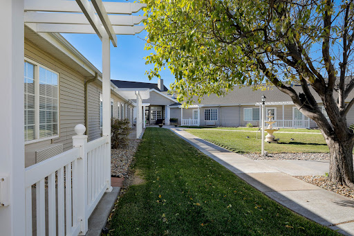 A peaceful pathway leading through a well-maintained residential area with lush green lawns.