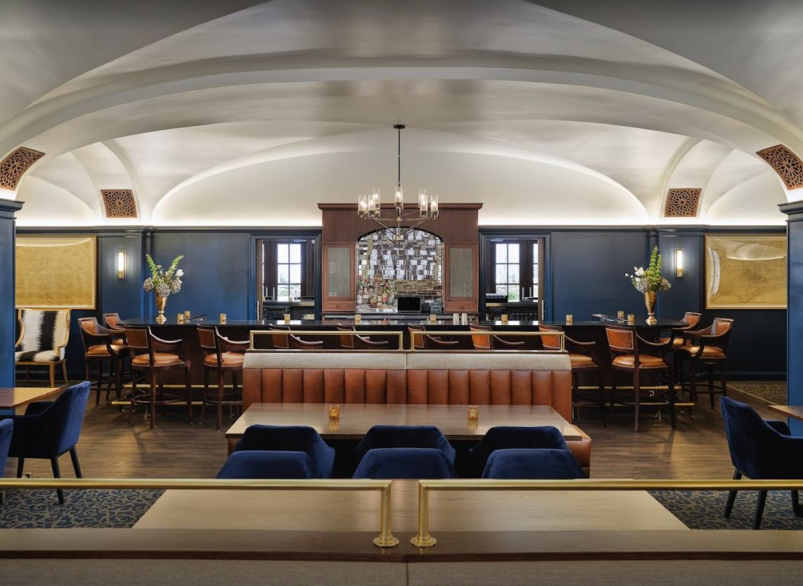 Elegant restaurant interior featuring a central bar and stylish seating.