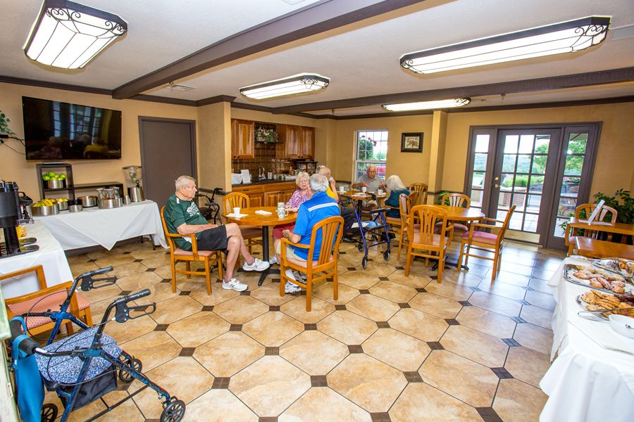 Seniors socializing in a community dining area.