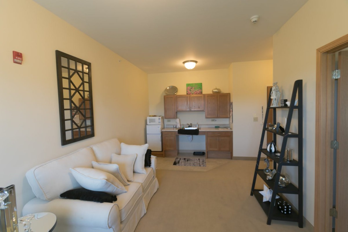 A cozy apartment with an open kitchenette and a comfortable living area.