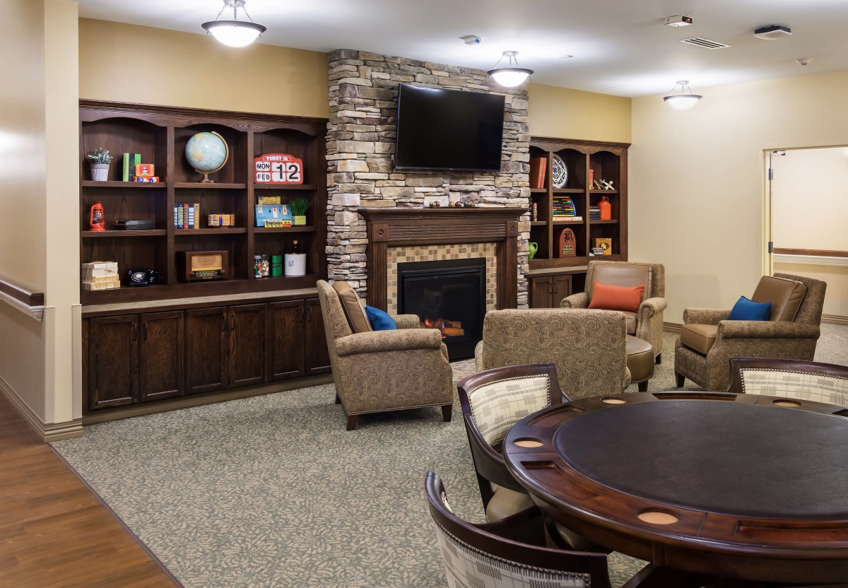 Cozy living room with a fireplace, comfortable seating, and a television.