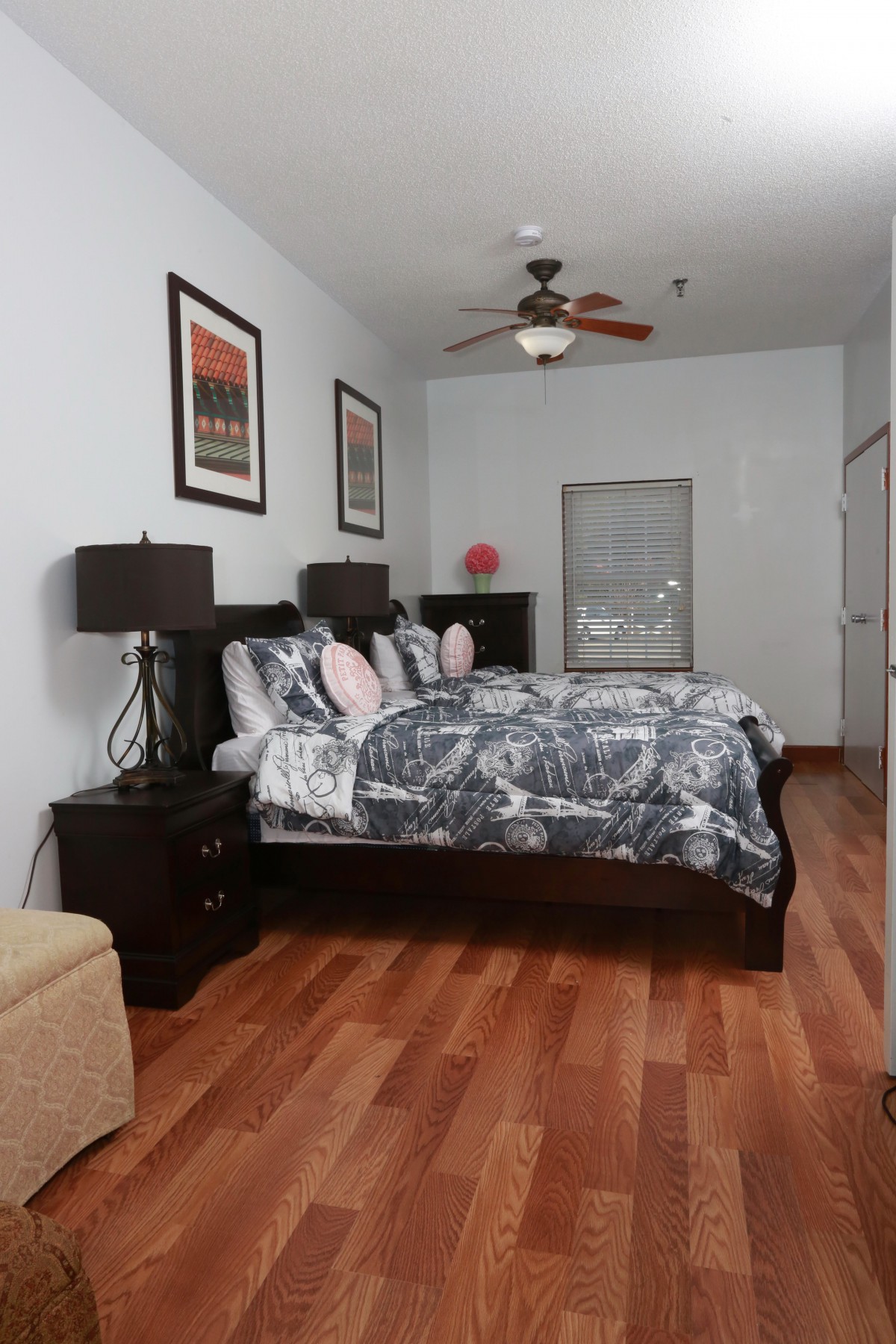 A cozy bedroom with a large bed, nightstands, and modern decor.