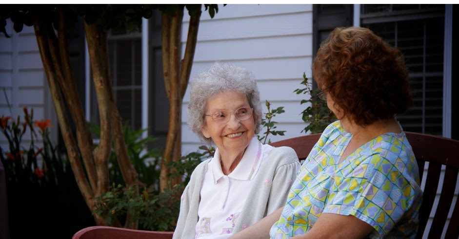 Two women enjoying a conversation outside.