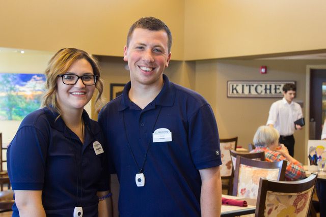 Two restaurant staff members smiling for a photo.