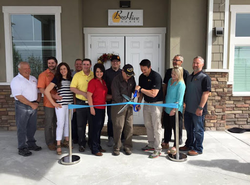 A group gathered for a ribbon-cutting ceremony to celebrate the opening of a new business.