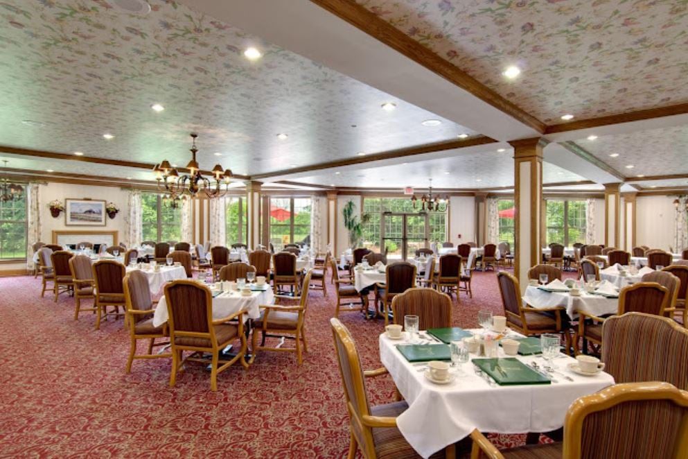 An elegant dining room with well-arranged tables and chandeliers.