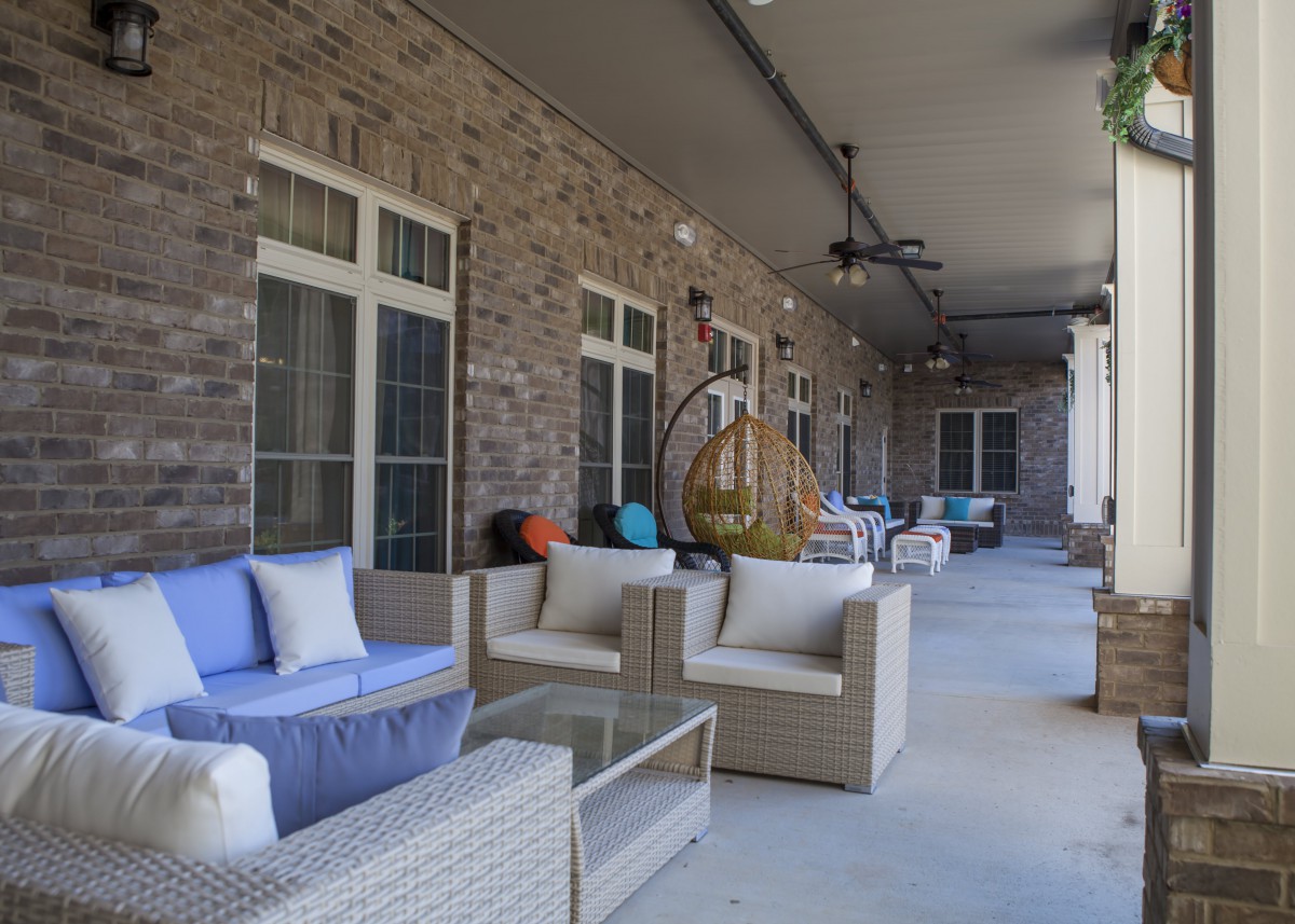 A cozy outdoor patio with comfortable seating and stylish decor.