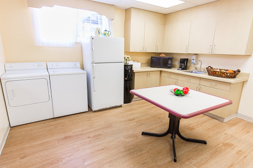 A spacious kitchen area featuring modern appliances and a dining table.