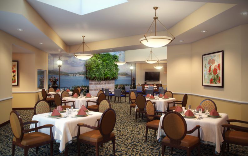 A well-lit dining area with neatly arranged tables and chairs.