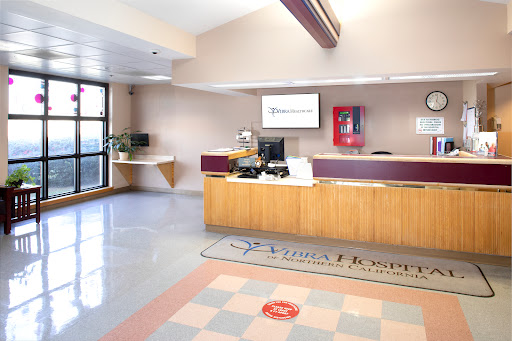 A modern reception area with a desk, computer, and welcoming decor.