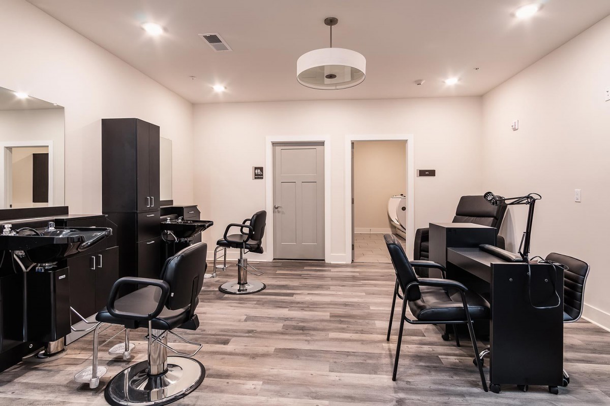 A modern salon interior with styling chairs and sleek design.