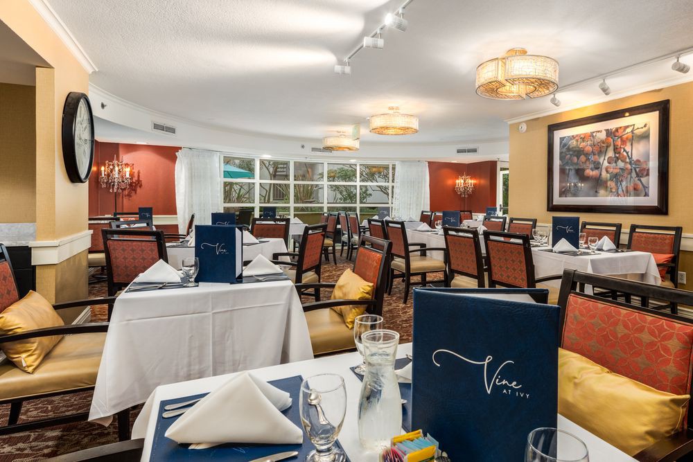 Elegant restaurant interior with tables set for dining, featuring a cozy and inviting atmosphere.