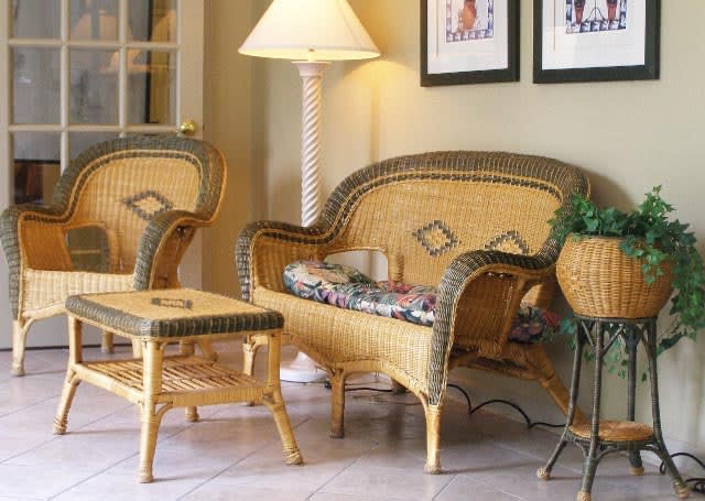 A cozy living room setup featuring wicker furniture and decor.