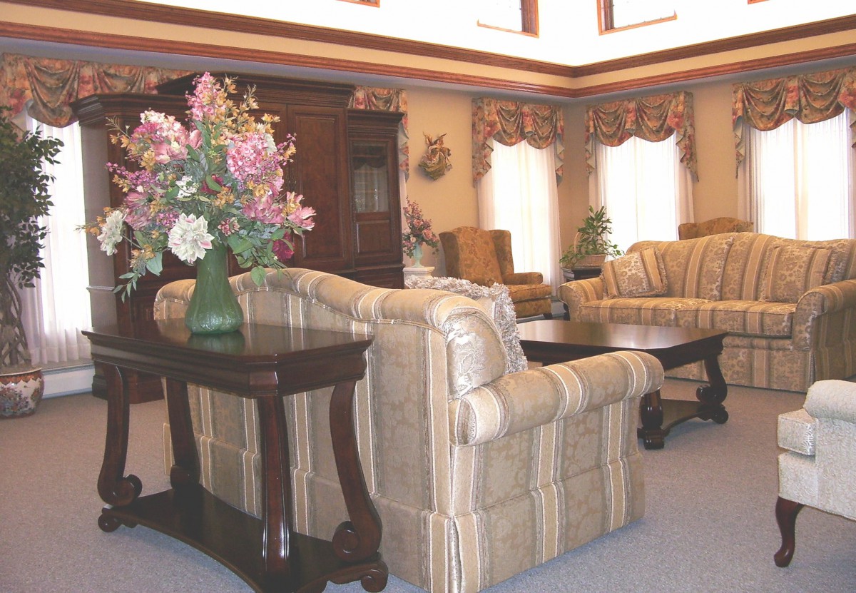 A traditional living room with classic furniture and floral decor.
