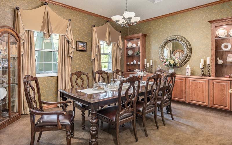 A traditional dining room with elegant furniture and decor.