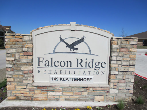 Welcome sign for Falcon Ridge Rehabilitation, featuring a stone design and an eagle emblem.