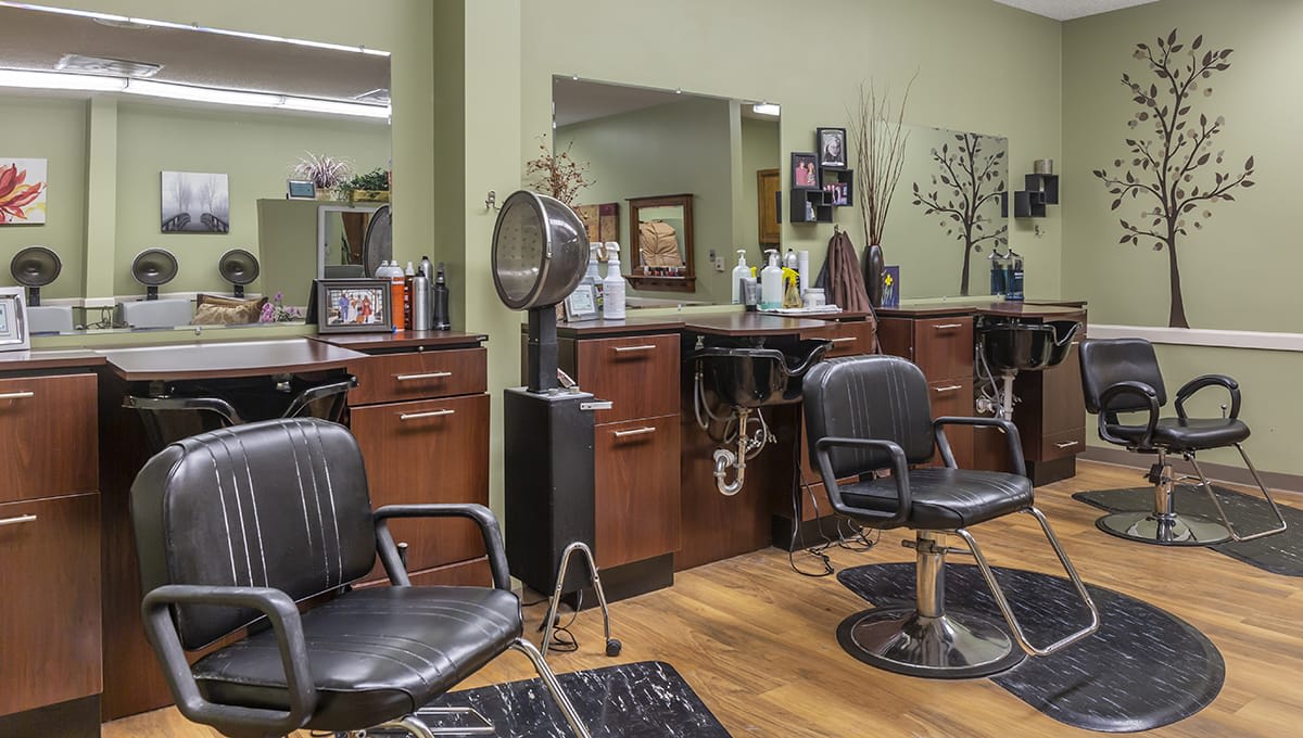 An interior view of a hair salon with chairs and styling stations.