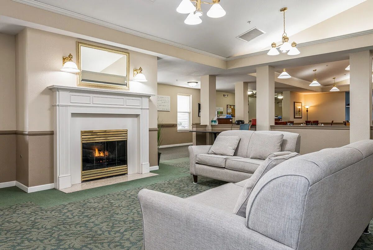A cozy living room with a fireplace and comfortable seating.