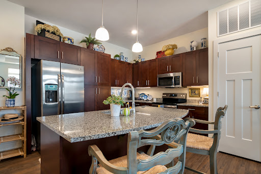A contemporary kitchen featuring elegant granite countertops and stainless steel appliances, perfect for cooking and entertaining.