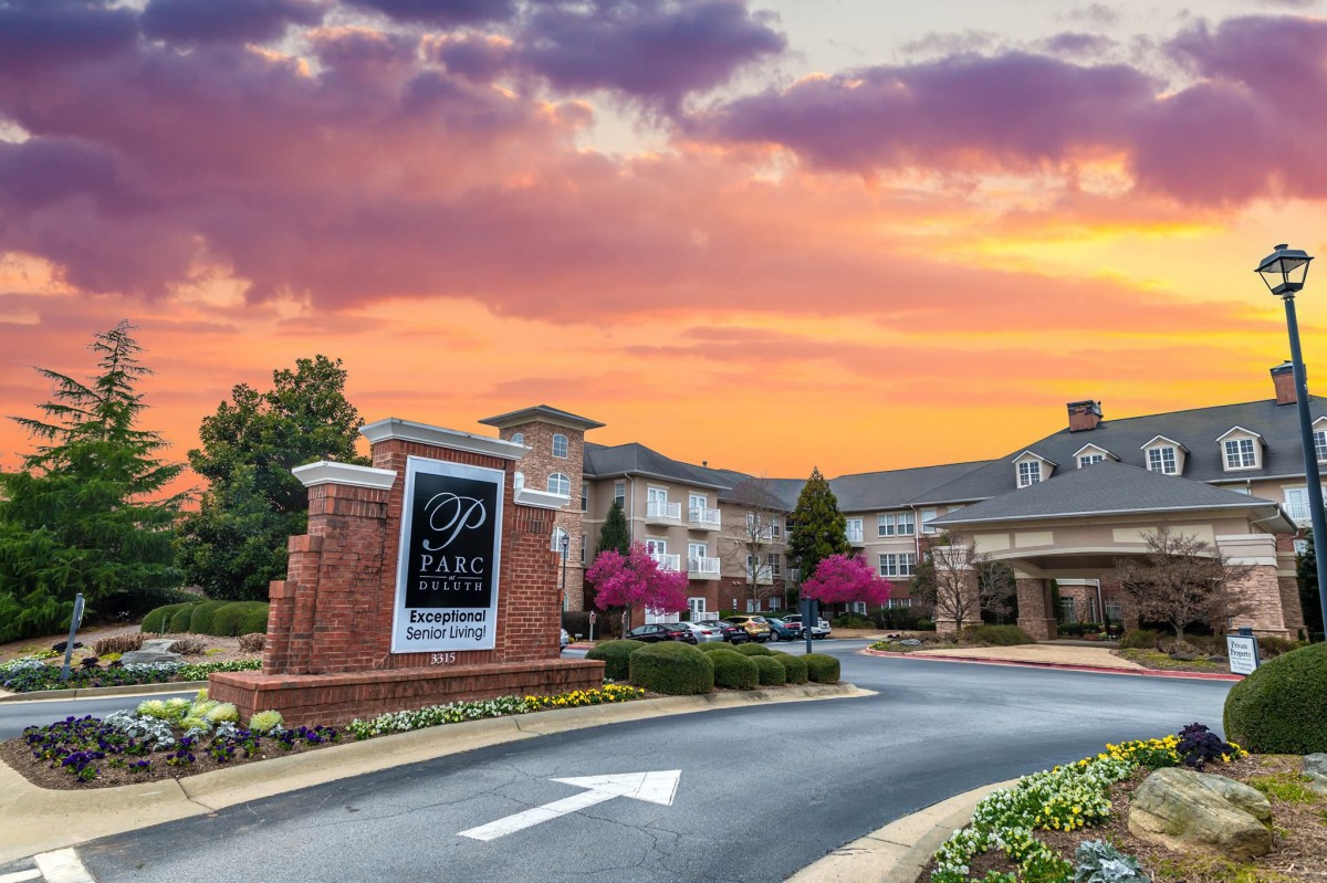 A picturesque view of a hotel entrance at sunset.