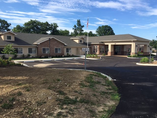 A single-story building with a parking lot, possibly a senior living facility.