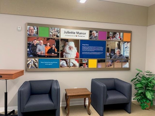 A welcoming waiting area featuring a photo collage on the wall, complemented by two comfortable chairs.