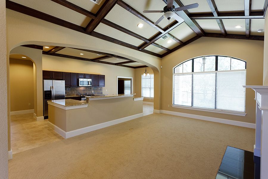 Spacious modern kitchen and living area with large windows and elegant design.