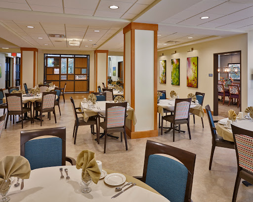 A beautifully arranged dining area featuring modern decor and vibrant wall art.