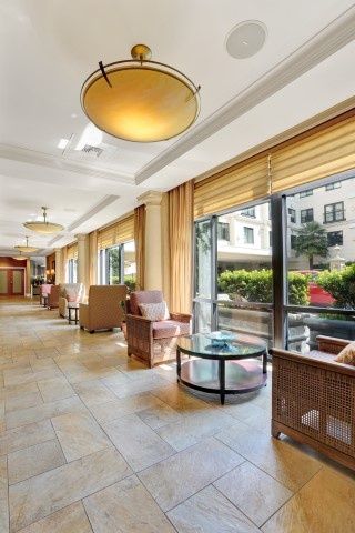 A bright and spacious hotel lobby with comfortable seating and large windows letting in natural light.