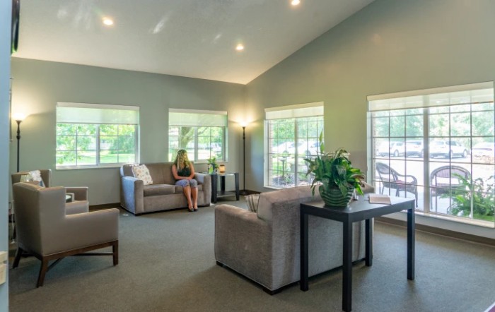 A bright and cozy living room with modern furnishings and large windows.