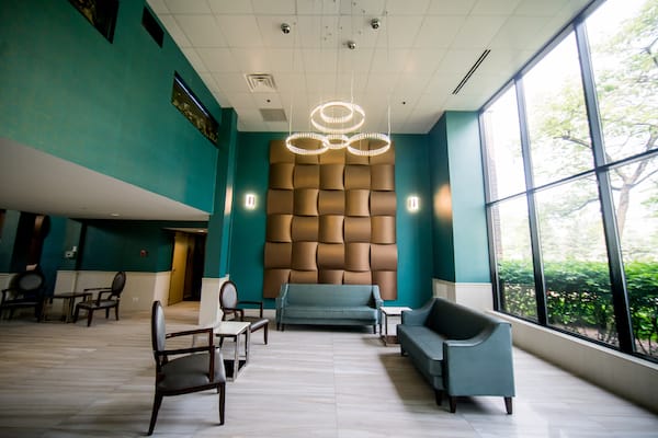 A stylish, modern lobby with contemporary furniture and unique lighting fixtures.