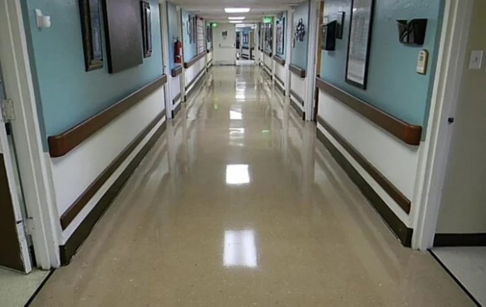 A clean, empty hospital corridor with bright lighting.