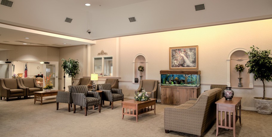 A cozy lobby with comfortable seating and an aquarium centerpiece.