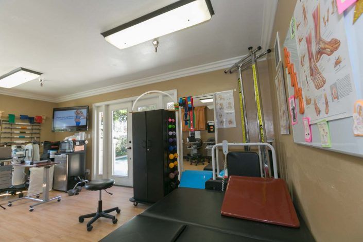 A spacious rehabilitation center equipped with exercise and therapy equipment.