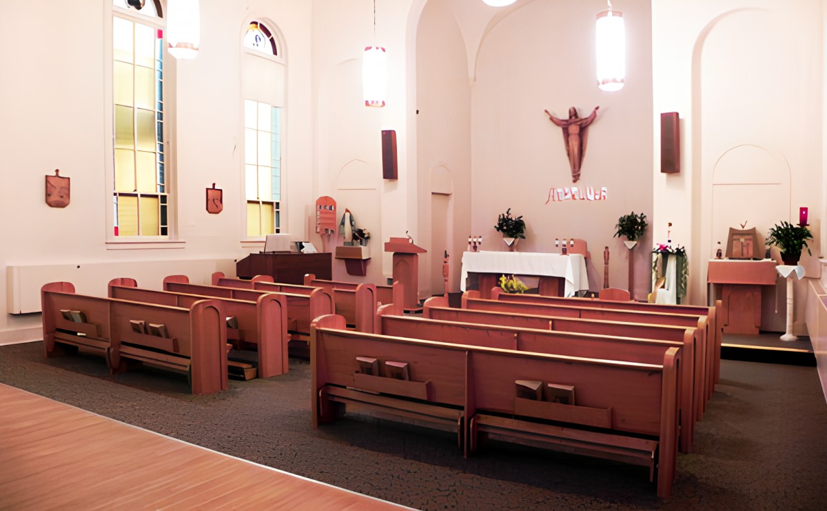 Interior view of a church showing the pews and altar area.