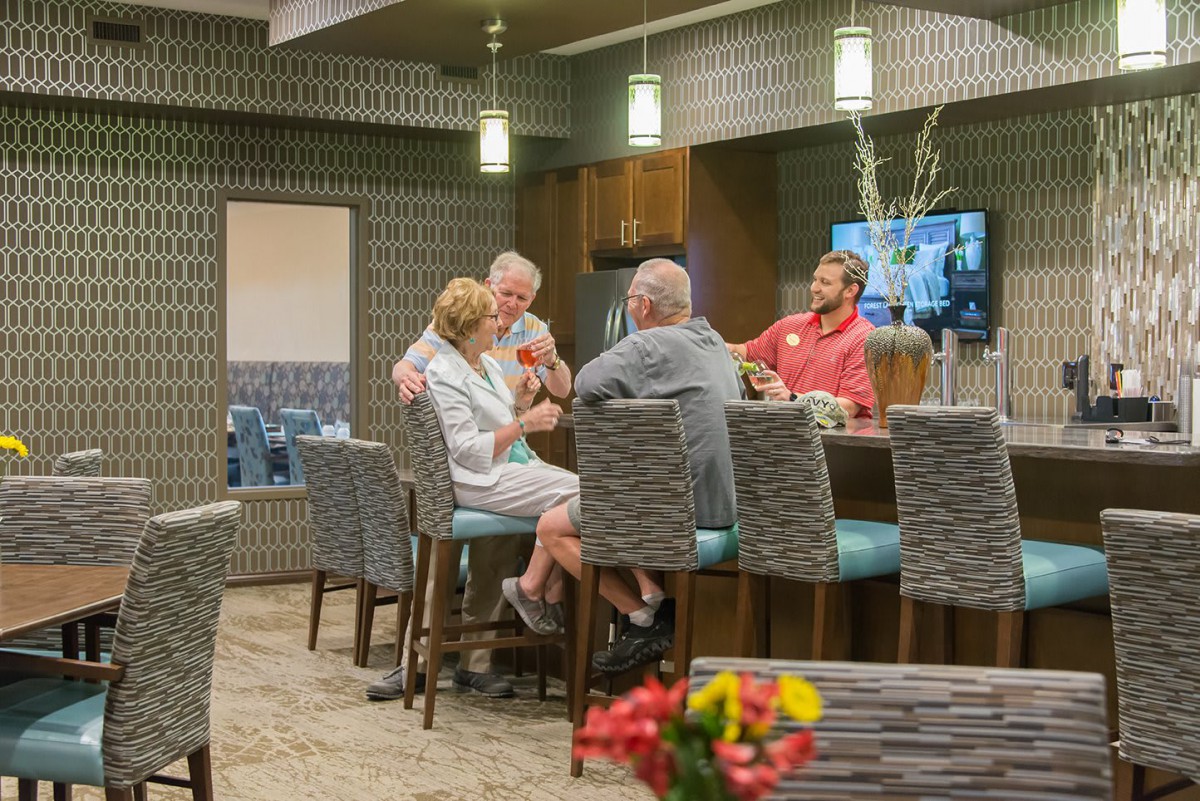 A group of people socializing at an indoor bar in a casual setting.