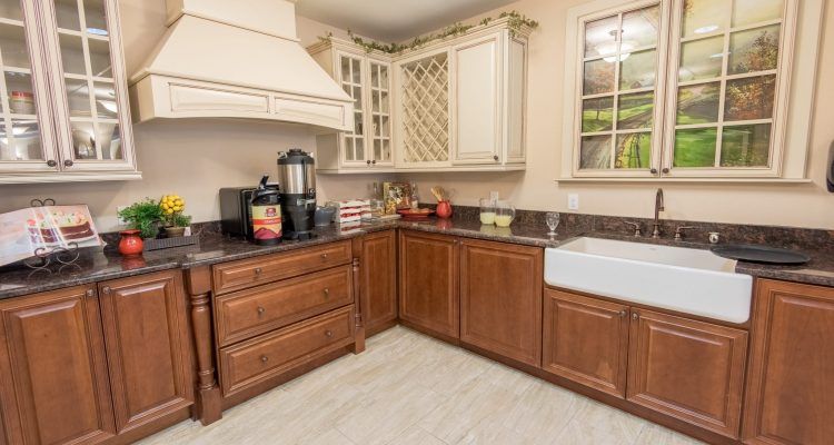 A cozy kitchen with wooden cabinets, a farmhouse sink, and modern appliances.
