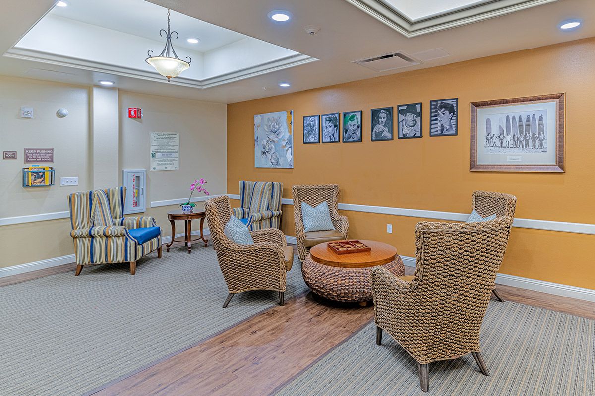 A cozy lobby area with comfortable seating and decorative artwork on the walls.