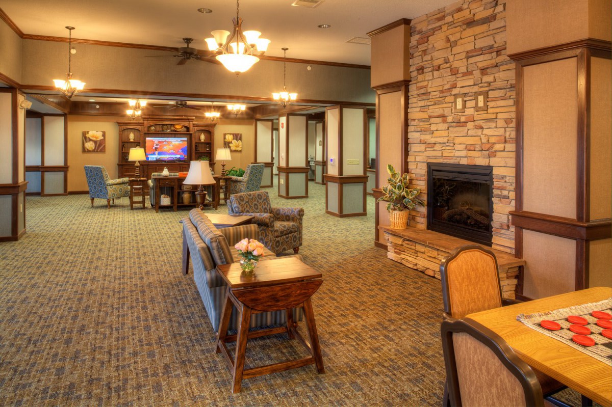 A comfortable living area featuring a fireplace, seating, and warm lighting.