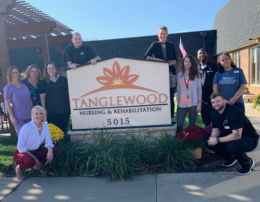 Team members gathered in front of Tanglewood Rehabilitation Center, showcasing their commitment to care and community.