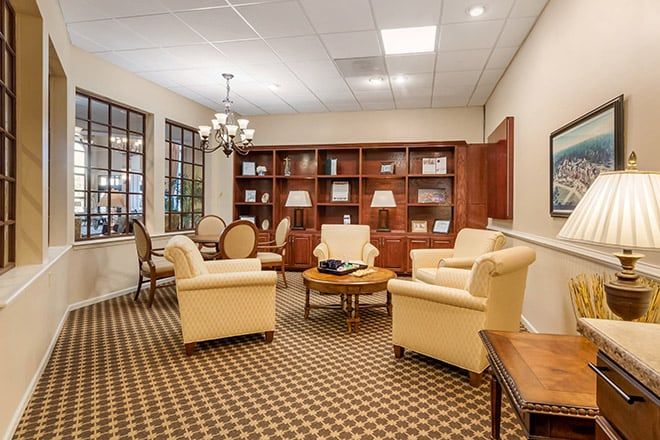 A cozy office lounge area with comfortable seating and bookshelves.