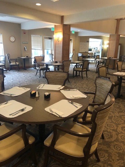 An empty dining area with neatly set tables and chairs.