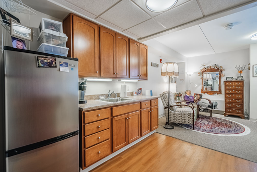 A well-equipped kitchen featuring wooden cabinets and modern appliances, showcasing a cozy interior design.